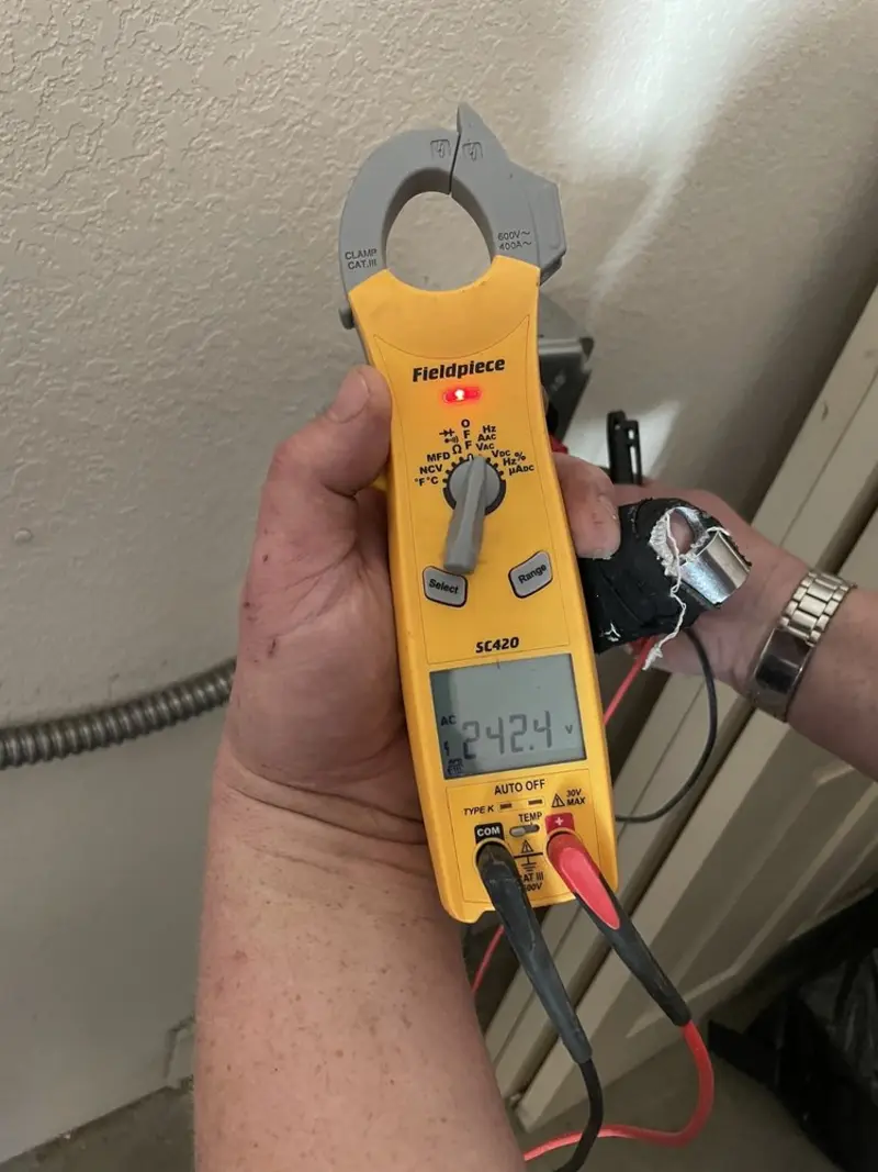 Voltage testing with clamp meter during Recessed Lighting Installation in Le Mars